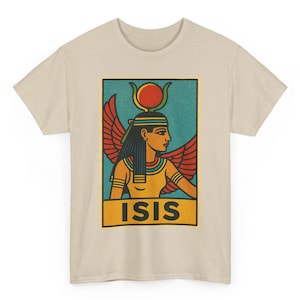 May include: Beige t-shirt featuring a rectangular graphic of the Egyptian goddess Isis. The graphic includes a teal background, red wings, and the word "ISIS" in yellow.