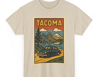 May include: Beige t-shirt with a vintage-style graphic of Tacoma, Washington. The design shows a bridge, mountain, car, and the word "TACOMA". The graphic uses blue, green, orange, and yellow. The t-shirt is made of a soft material.
