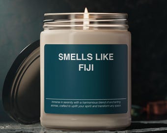 May include: A beige candle in a glass jar with a teal label that reads "SMELLS LIKE FIJI". The label also includes the text "Immerse in serenity with a harmonious blend of enchanting aromas, crafted to uplift your spirit and transform any space."