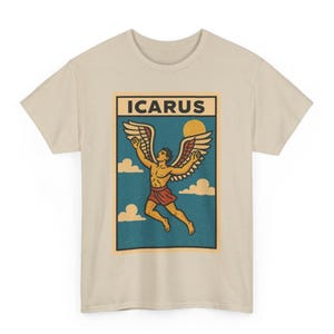 May include: Beige t-shirt featuring a retro graphic of Icarus with outstretched wings, a red skirt, and a sun. The design is set against a blue background with clouds and the word "ICARUS" at the top.