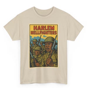 May include: A beige t-shirt featuring a graphic of soldiers in olive green uniforms and helmets, holding rifles. The graphic includes the text "HARLEM HELLFIGHTERS" in red and yellow, set against a blue sky background.