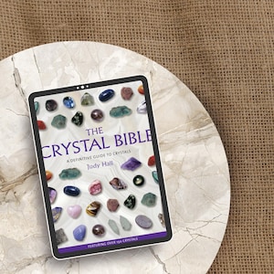 May include: The Crystal Bible: A Definitive Guide to Crystals by Judy Hall, featuring over 150 crystals. The cover features a variety of crystals in different colors and shapes.