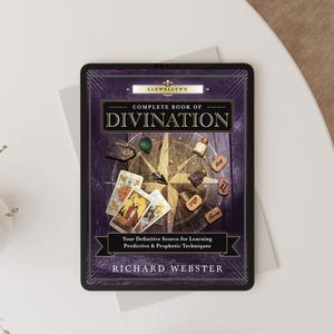 May include: A digital tablet displaying the cover of Llewellyn's Complete Book of Divination by Richard Webster. The cover features a compass rose background, tarot cards, small glass bottles, and wooden runes in a purple and gold color scheme.