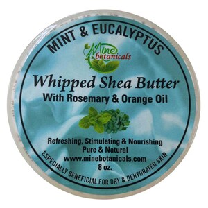 May include: A white jar with a blue and green label. The label reads "Mint & Eucalyptus Whipped Shea Butter with Rosemary & Orange Oil". It also says "Refreshing, Stimulating & Nourishing Pure & Natural www.minebotanicals.com 8 oz. Especially Beneficial for Dry & Dehydrated Skin".