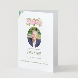 May include: A white memorial card featuring a photograph of a smiling man in a suit, adorned with a floral arrangement. The text reads "In Loving Memory" and the name "John Smith" with dates and family titles.