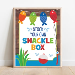 May include: A printable sign with a wooden background and blue water. It says "Stock Your Own Snackle Box" with colorful fish and a fishing rod.