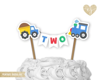 May include: Printable cake topper featuring a blue train, a yellow dump truck, and a banner that says "TWO" in red, blue, and green letters. The topper is perfect for a second birthday party.