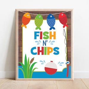 May include: A white sign with a wooden background and a blue, green, and white border. The sign says "Fish N' Chips" in colorful letters. There are four fish with different colored fins and tails hanging from a string at the top of the sign. A red and white fishing bobber is in the water below the sign.