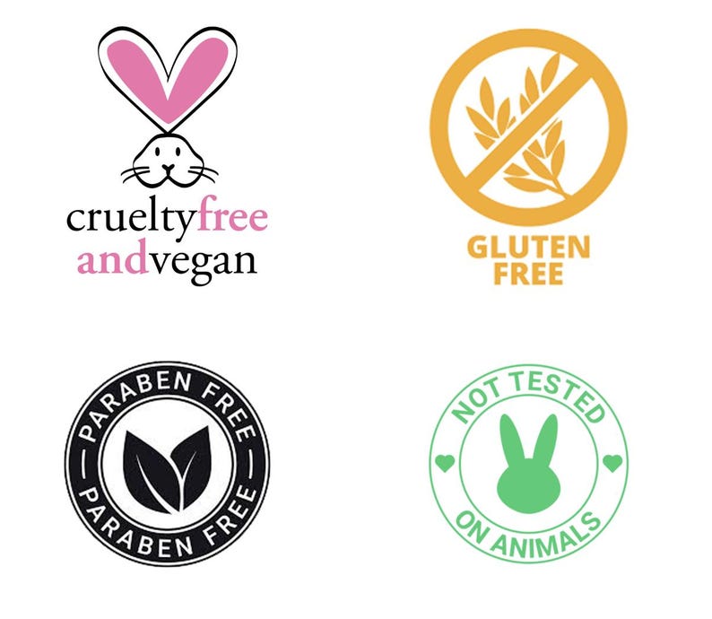 Puede incluir: Se muestran cuatro etiquetas de productos. Incluyen: "cruelty free and vegan" con un conejito rosa, "gluten free" con un s&iacute;mbolo de trigo tachado, "paraben free" en un dise&ntilde;o circular y "not tested on animals" con un conejito verde.