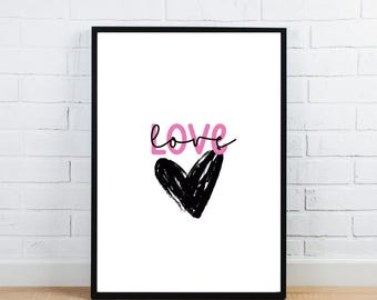 May include: A framed art print with the word "love" in pink and black script above a black heart shape on a white background. The artwork is in a black frame and is displayed against a white brick wall.