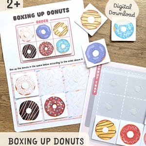May include: A children's educational game called "Boxing Up Donuts". The game features donut-themed cards and a game board. The board has spaces for the donuts to be arranged in a specific order. The game is labelled "Digital Download".