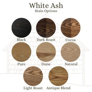 May include: Image showcasing White Ash stain options. The image displays eight circular samples in various colors: Black, Dark Roast, Cocoa, Pure, Dune, Natural, Light Roast, and Antique Blend. The text "White Ash Stain Options" is at the top.