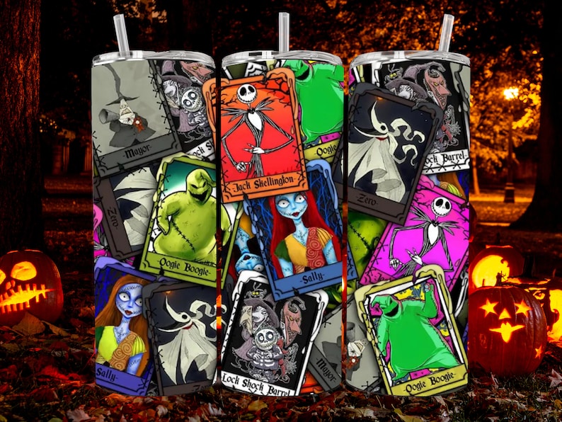May include: A stainless steel tumbler with a colourful design featuring characters from The Nightmare Before Christmas. The design includes Jack Skellington, Sally, Oogie Boogie, and Zero. The tumbler is surrounded by pumpkins and autumn foliage.