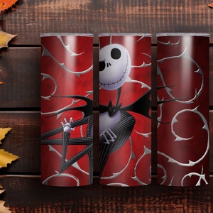 May include: Three red and silver insulated tumblers featuring a design of Jack Skellington from The Nightmare Before Christmas. The design includes a white skull, black pinstripe suit, and silver thorn accents.