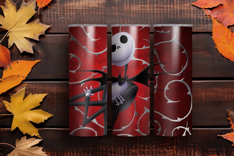 May include: Three red and silver insulated tumblers featuring a design of Jack Skellington from The Nightmare Before Christmas. The design includes a white skull, black pinstripe suit, and silver thorn accents.