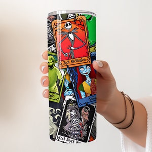 May include: A stainless steel tumbler featuring a colourful collage of characters from The Nightmare Before Christmas. The characters include Jack Skellington, Sally, Oogie Boogie, and Lock, Shock, and Barrel. The tumbler is a great way to show your love for the film.