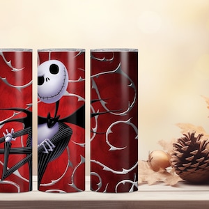 May include: A set of three stainless steel tumblers featuring a design of Jack Skellington from The Nightmare Before Christmas. The tumblers have a red background with silver thorn-like accents. Jack is depicted in his classic black and white suit.