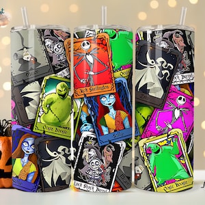 May include: A stainless steel tumbler with a colourful design featuring characters from the movie The Nightmare Before Christmas. The design includes Jack Skellington, Sally, Oogie Boogie, and Zero. The tumbler is surrounded by a black background with a white border.