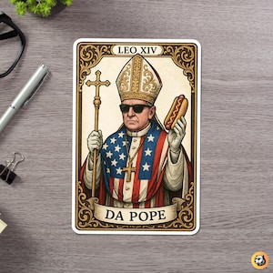 May include: A sticker depicting a cartoon pope wearing sunglasses and holding a hot dog. The pope's robes are designed with the American flag. The sticker has the text "LEO XIV" at the top and "DA POPE" on a banner at the bottom.