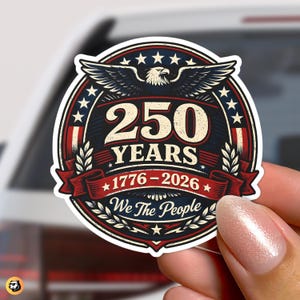 May include: A circular sticker with a patriotic design. The sticker features a central emblem with the text "250 YEARS 1776-2026" and an eagle. The words "We The People" are also included. The design incorporates red, white, and blue colours.