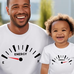 May include: A white ceramic mug with a black handle and the text "But First, Coffee" in a bold, black font. The mug is set against a blurred background, suggesting a cozy setting. The mug appears to be approximately 4 inches tall.