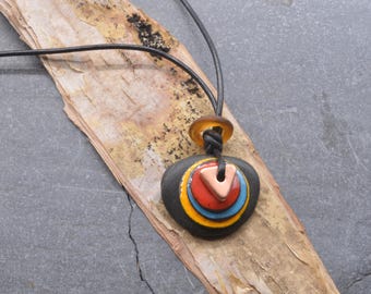 Pop   a black stone and enamel Maine sea worry stone necklace on an adjustable leather cord with  glass African trade bead