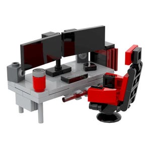 Könnte beinhalten: Ein Miniatur-Gaming-Setup aus Bausteinen. Der Schreibtisch verfügt über zwei schwarze Monitore, einen rot-grauen Zylinder und einen schwarzen Lautsprecher. Ein rot-schwarzer Gaming-Stuhl befindet sich vor dem Schreibtisch.