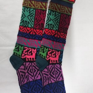May include: Pair of colorful knee-high socks with a geometric and animal print design. The socks are made of a soft, knitted fabric and feature a variety of colors, including pink, blue, green, red, and yellow.