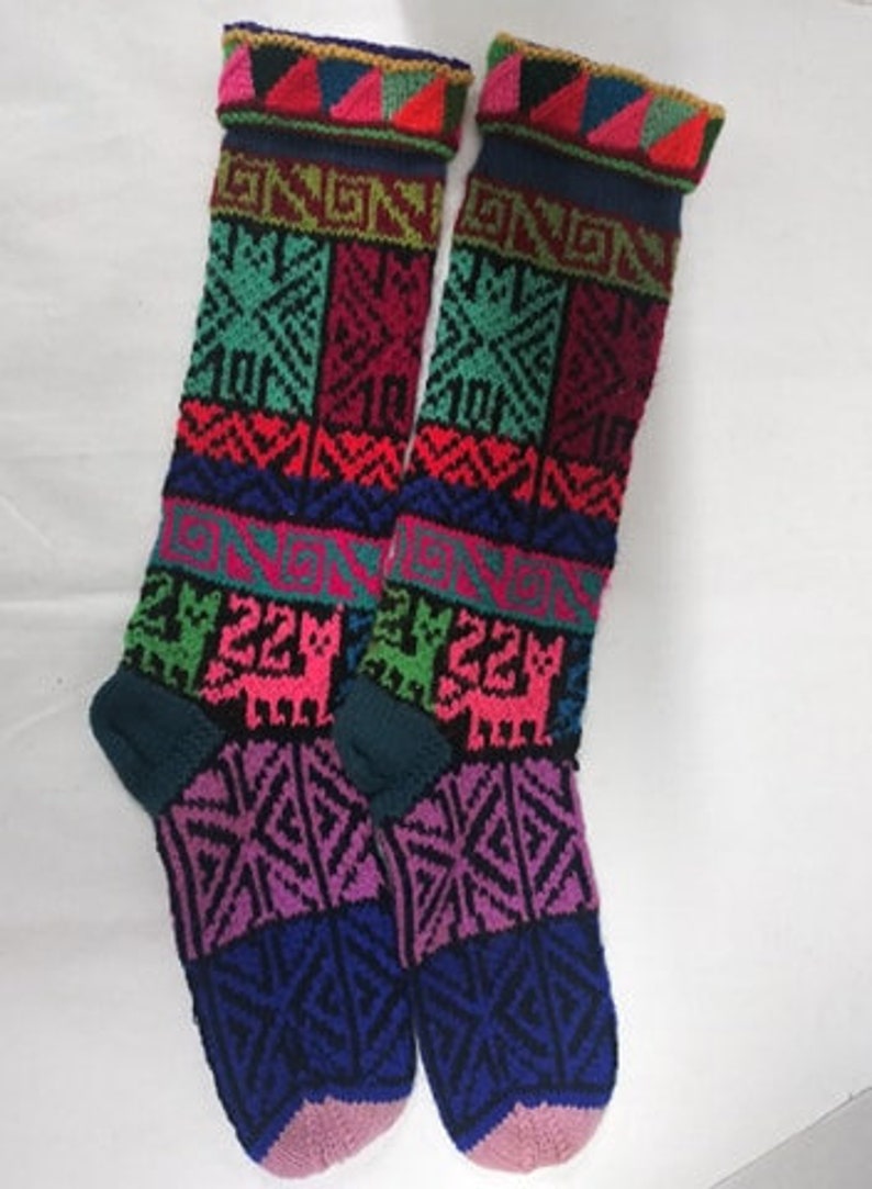 May include: Pair of colorful knee-high socks with a geometric and animal print design. The socks are made of a soft, knitted fabric and feature a variety of colors, including pink, blue, green, red, and yellow.