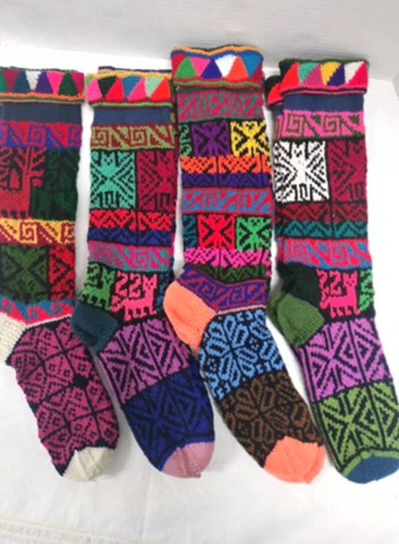 May include: Five pairs of colorful knitted socks with geometric patterns. The socks are made of wool and have a variety of colors, including red, blue, green, yellow, and purple.