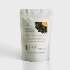 May include: A white pouch of "72 Spearmint PCOS Power Potion Tea" with text and a small image of tea leaves and a cup of tea. The pouch also has a QR code and the words "Caffeine Free". The net weight is 2.25 oz.