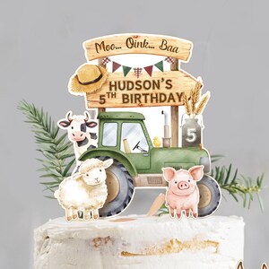 May include: A decorated cake with a farm theme. The cake is topped with a green tractor, farm animals, and a sign that reads "Hudson's 5th Birthday". Additional farm animal figurines include a cow, sheep, pig, donkey, goose, chick, and hen.