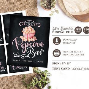 May include: Printable sign for a popcorn bar with the text "Make Your Own Popcorn Bar" and a pink and white popcorn bucket. The sign also includes the text "Scoop, Sprinkle, Enjoy".