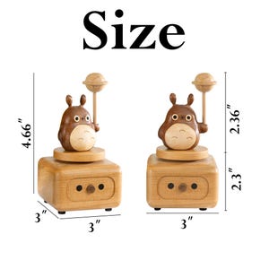 May include: Wooden music box featuring a brown cartoon character holding a star. The music box is 4.66 inches tall, 3 inches wide, and 2.36 inches deep.
