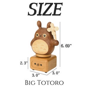 May include: A wooden music box featuring a brown owl with a flower on its head. The music box is 6.69 inches tall, 3 inches wide, and 2.3 inches deep. The music box is made of wood and has a brown owl design. The owl has a flower on its head and is holding a flower in its right hand. The music box is a great gift for any fan of owls or music boxes.