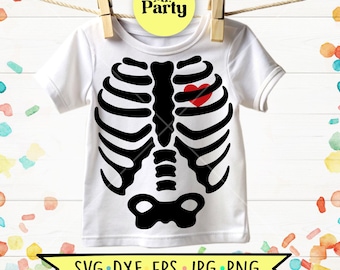 May include: A white short-sleeved t-shirt featuring a black graphic of a human rib cage and sternum on the front. A small red heart is positioned on the left side of the rib cage. The shirt is displayed hanging from a wooden clothespin.
