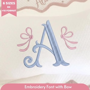 May include: An embroidered letter "A" in light blue, flanked by pink bows, on a white background. The text "Embroidery Font with Bow" is at the bottom. The image also includes text that says "6 Sizes BX +10 Format".