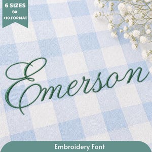 May include: An embroidery font design featuring the name Emerson stitched in dark green thread on a light blue and white gingham fabric background. A small cluster of white baby's breath flowers is visible in the upper right corner of the image.
