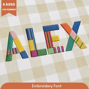 May include: The name ALEX is displayed in a colorful, multi-patterned embroidery font. Each letter is composed of various geometric segments featuring stripes, solids, and textures in shades of blue, green, yellow, pink, orange, and magenta.