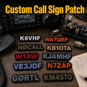 May include: A collection of rectangular embroidered patches featuring various amateur radio call signs in different colors including white, orange, olive green, red, blue, and grey, arranged on a surface with radio equipment and a frequency log.