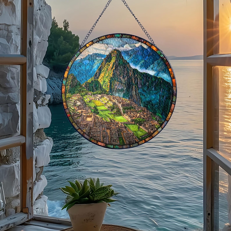 May include: A round stained glass window depicting Machu Picchu, with a chain for hanging. The artwork features a vibrant landscape of green mountains, ancient ruins, and a blue sky. The window is framed with colorful glass.