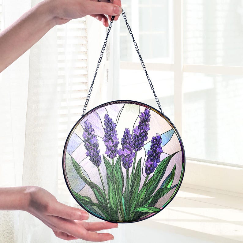May include: A round stained glass window hanging with a chain. The design features purple lavender flowers with green leaves on a white background.