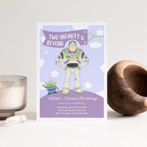 May include: A birthday invitation featuring Buzz Lightyear from Toy Story. The invitation has a purple background with the text "Two Infinity & Beyond" and "Mateo's Second Birthday". The invitation includes event details.