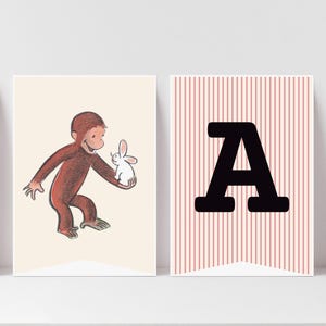 May include: Two decorative banners. One features a brown cartoon monkey holding a white rabbit on a cream background. The other banner has a large black letter "A" on a pink and white striped background.