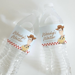 May include: Two clear plastic water bottles featuring light blue labels with the text Woody's Water and Editable Water Label. Each label displays a cartoon character wearing a brown cowboy hat, yellow shirt, and red neckerchief above a red checkered border.
