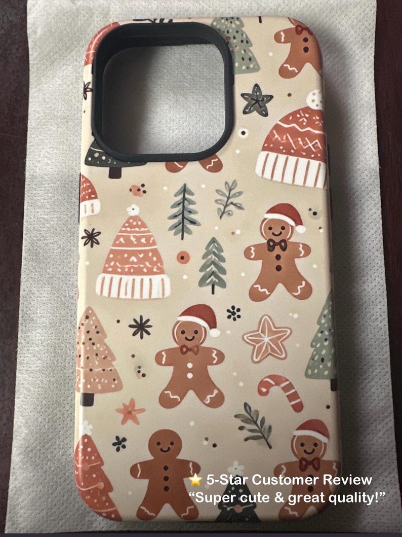 Real customer photo showing the Pastel Gingerbread Christmas Phone Case in beige tones. Cute festive design with gingerbread men and Christmas trees.