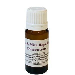 May include: A brown glass bottle with a white cap, labelled "Mite & Mite Repellent Concentrate." The label includes instructions and lists essential oils. The bottle is designed for use as a spray.