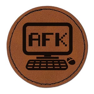 May include: A circular brown leather patch featuring a black laser-engraved graphic of a computer monitor displaying the text AFK, accompanied by a keyboard and a computer mouse. The patch has a stitched border around the entire circumference.