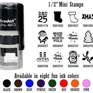 May include: A black and gray Trodat printy 4612 stamp with various Christmas-themed designs, including a Santa Claus, Christmas tree, and stocking. The image also shows eight ink color options: black, brown, blue, purple, green, red, orange, and pink.