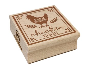 May include: A wooden stamp with a brown border and text that reads "FARM FRESH chicken EGGS". The stamp features a chicken illustration and decorative sprigs. The stamp is made of light-colored wood.